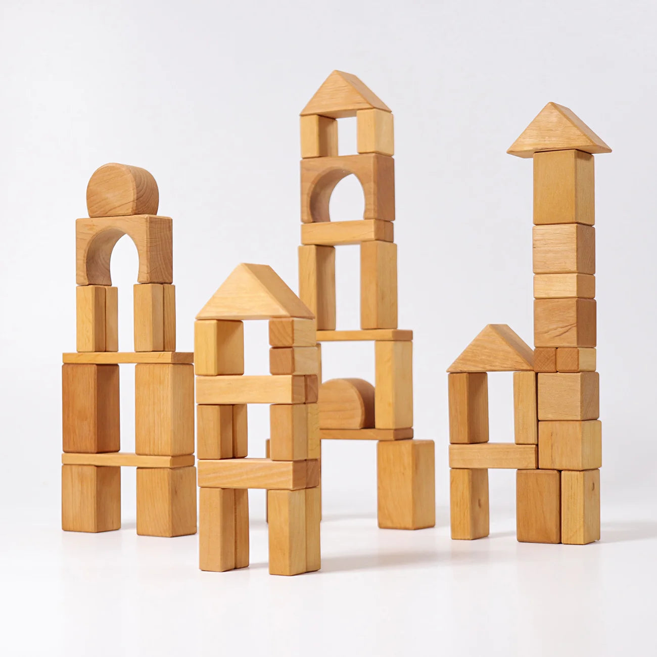 Set of wooden building blocks stacked on a white background
