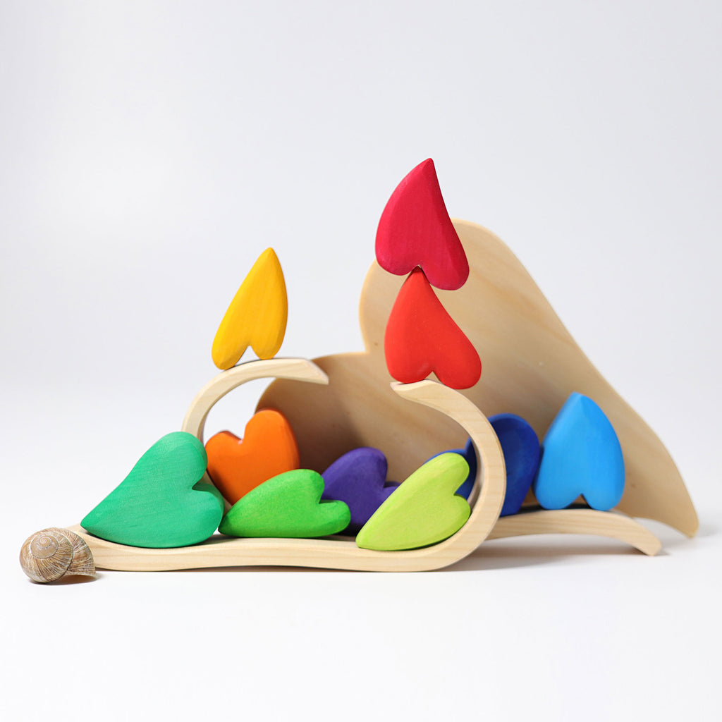 Colorful wooden toy with heart-shaped pieces on a white background