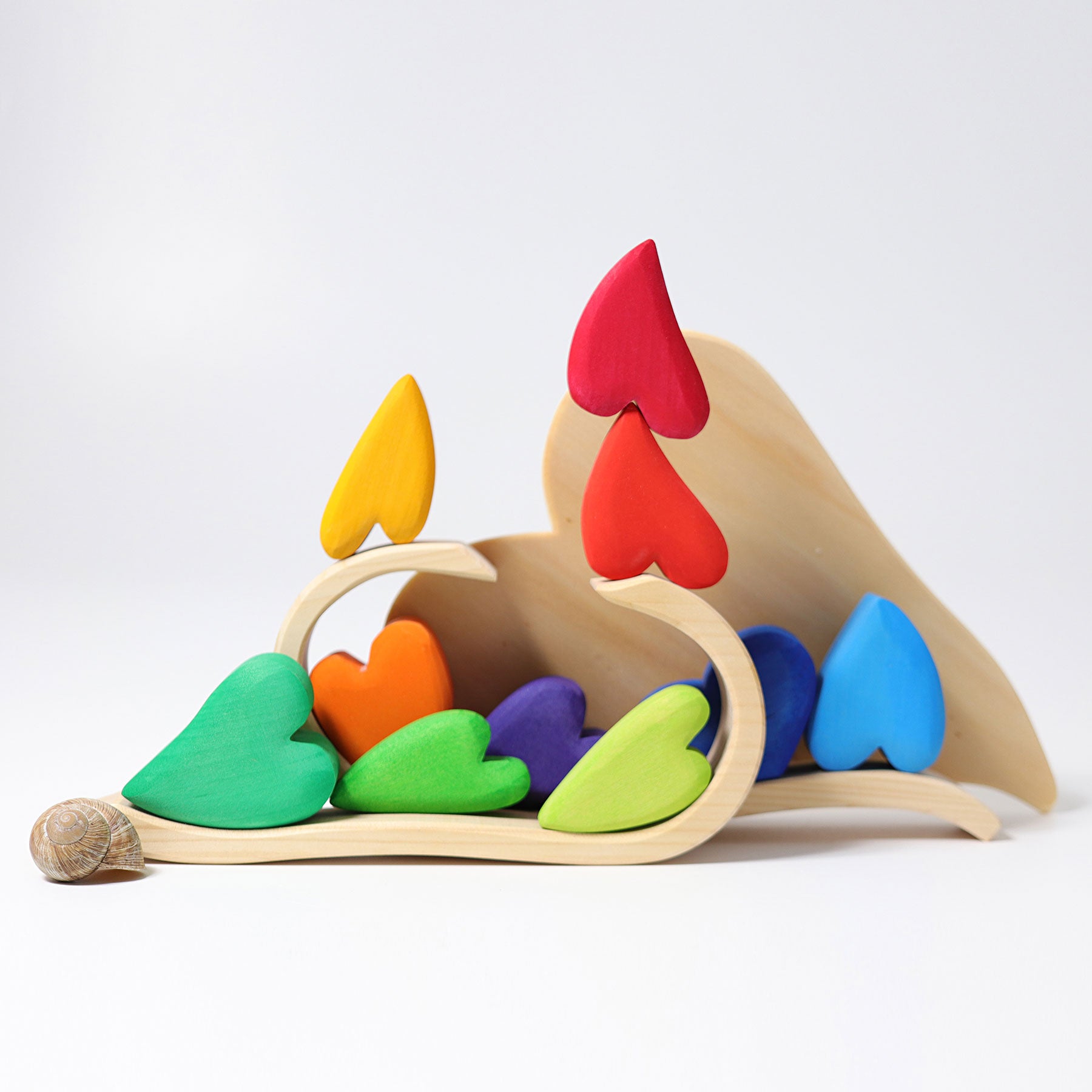 Colorful wooden toy with heart-shaped pieces on a white background