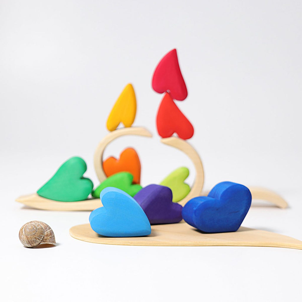 Colorful heart-shaped wooden toys on a white background