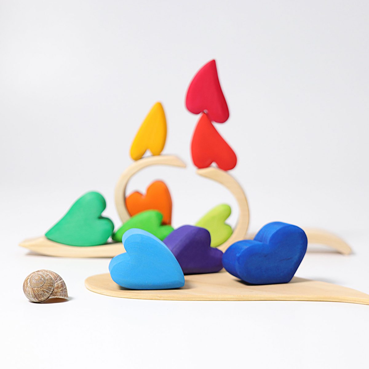 Colorful heart-shaped wooden toys on a white background