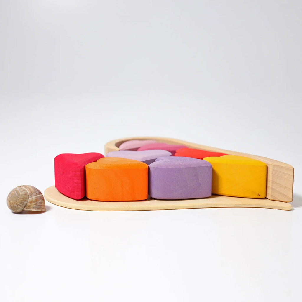 Colorful wooden toy with geometric shapes on a white background