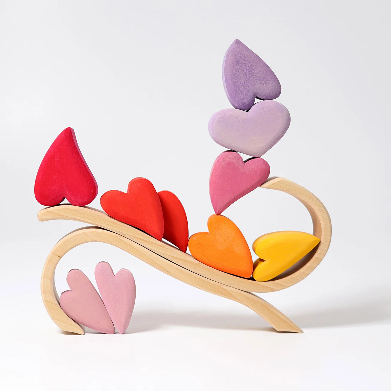 Colorful heart-shaped wooden toys on a white background