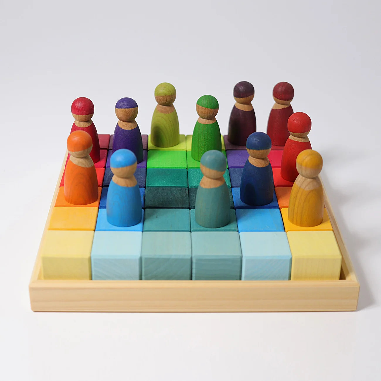 Colorful wooden pegs on a grid with a white background