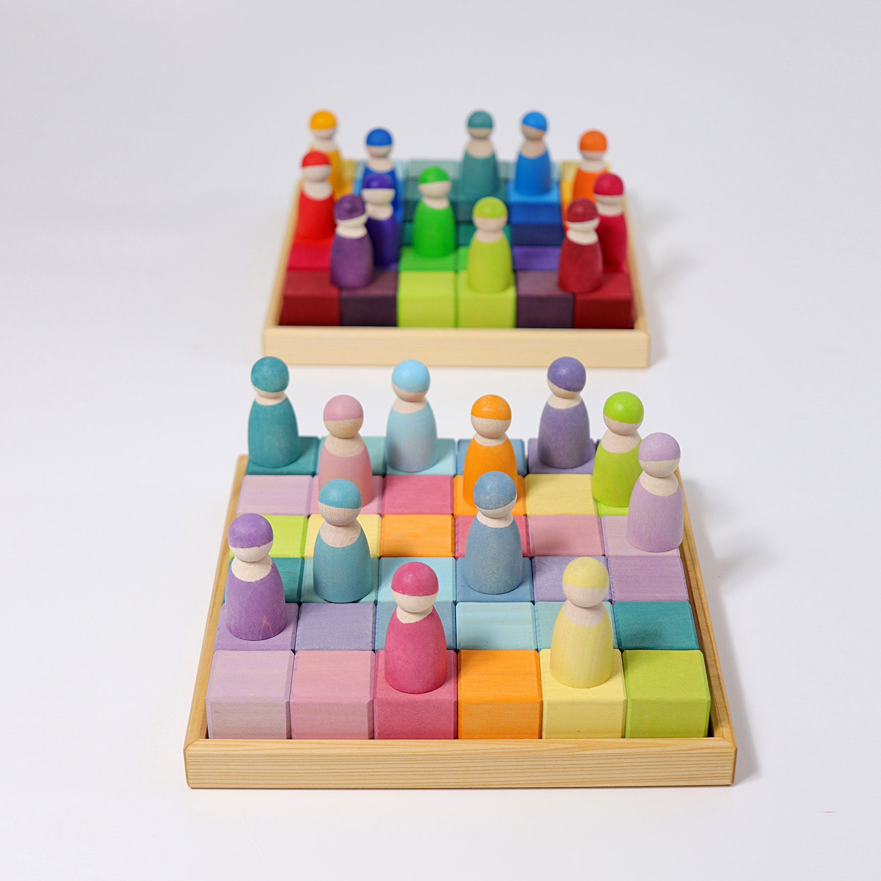 Colorful wooden peg people on a grid with a white background