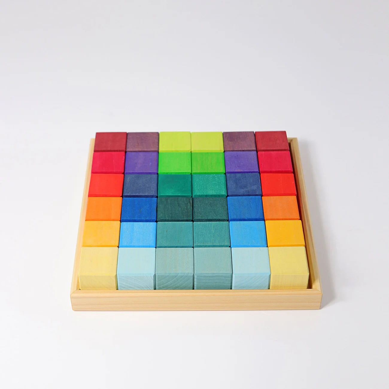 Colorful wooden blocks in a box on a white background