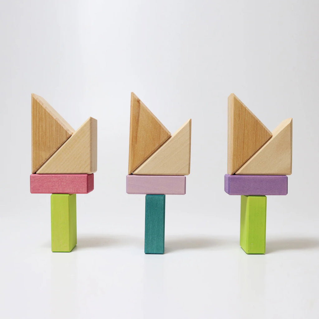 Three wooden tangram-like puzzle toys on a white background