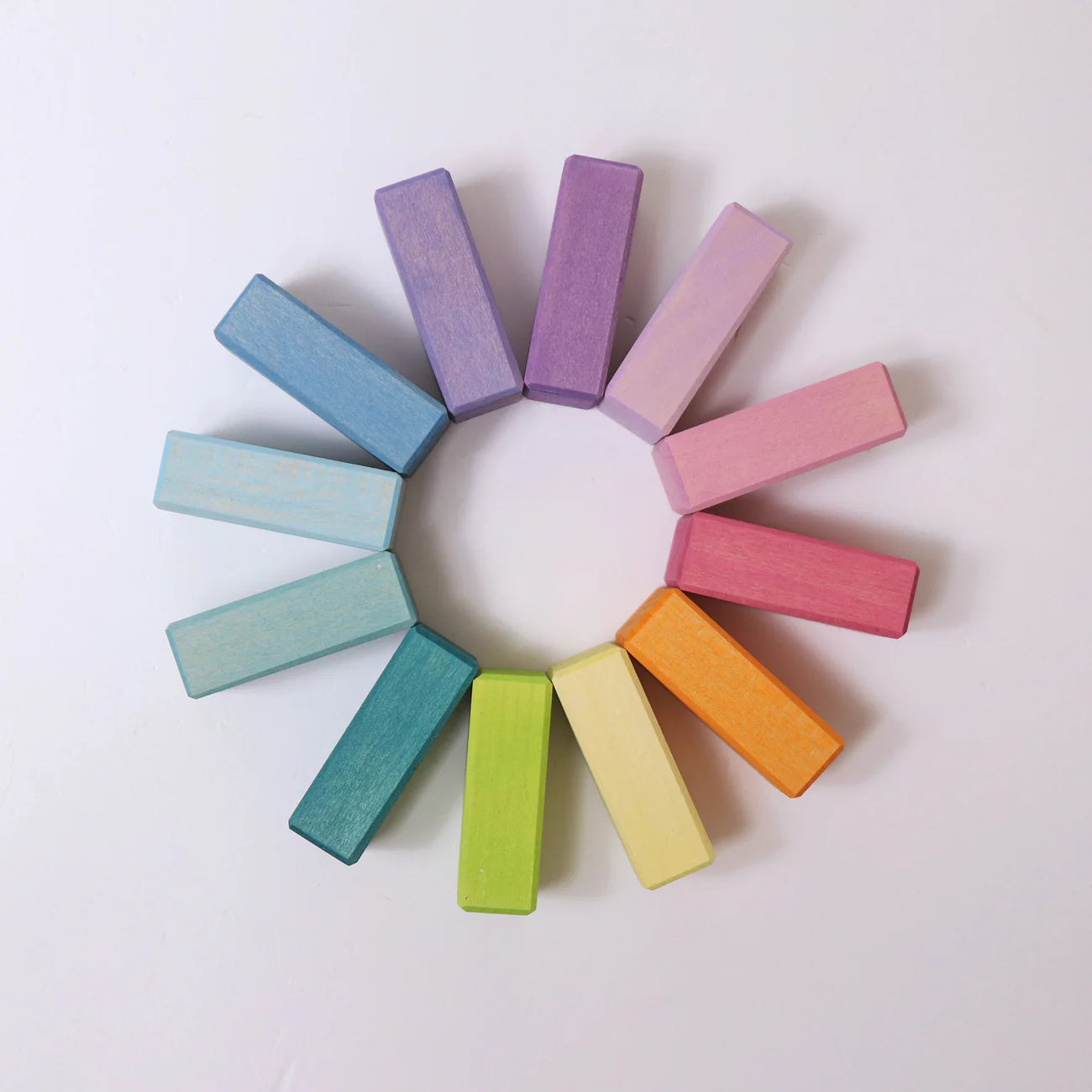 Colorful wooden blocks arranged in a circular pattern on a light background