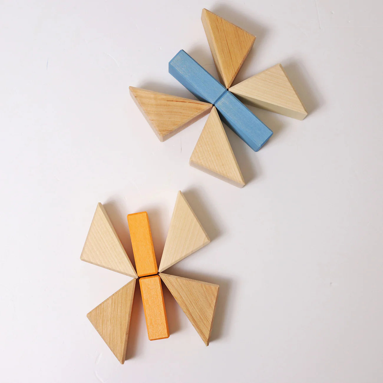 Wooden geometric blocks in various colors on a light background