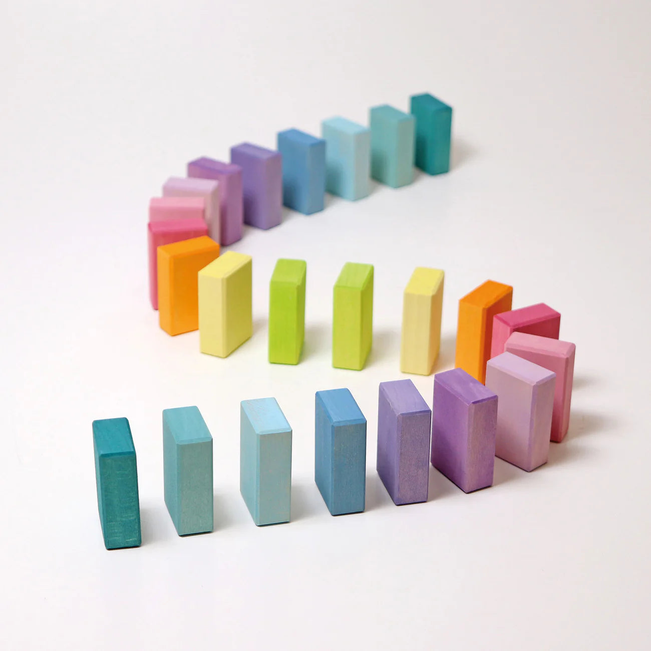 Colorful wooden blocks arranged in a pattern on a white background