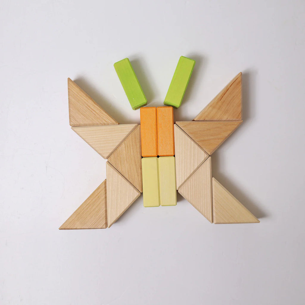 Wooden tangram puzzle shaped like a butterfly on a white background