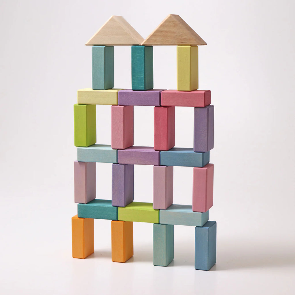 Colorful wooden blocks stacked into a tower on a white background