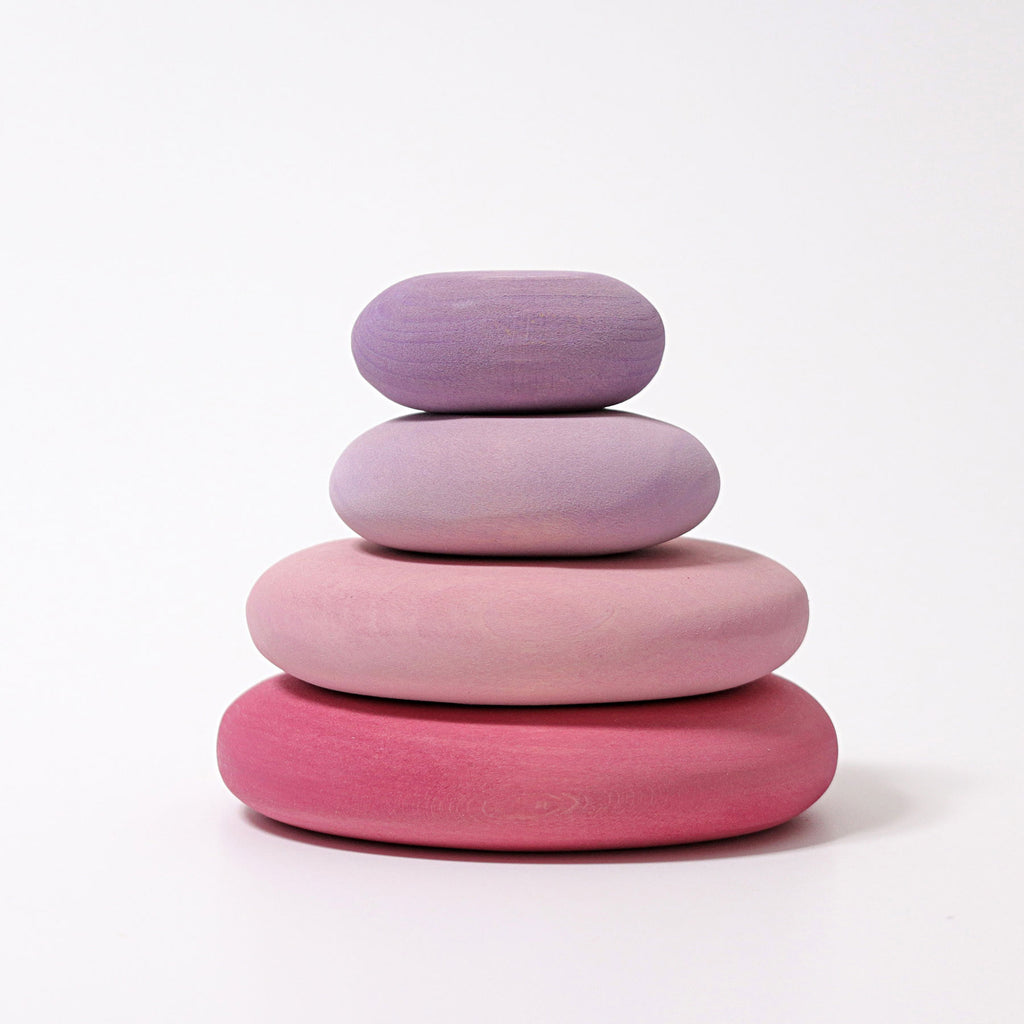 Stack of four  colorful wooden stones on a white background