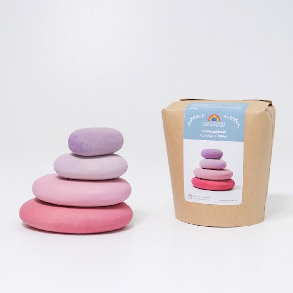 Stack of colorful stacking stones next to its packaging on a white background