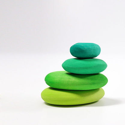 Stack of green wooden stones on a white background