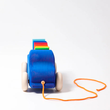 Colorful toy with blue base and wooden wheels on a white background