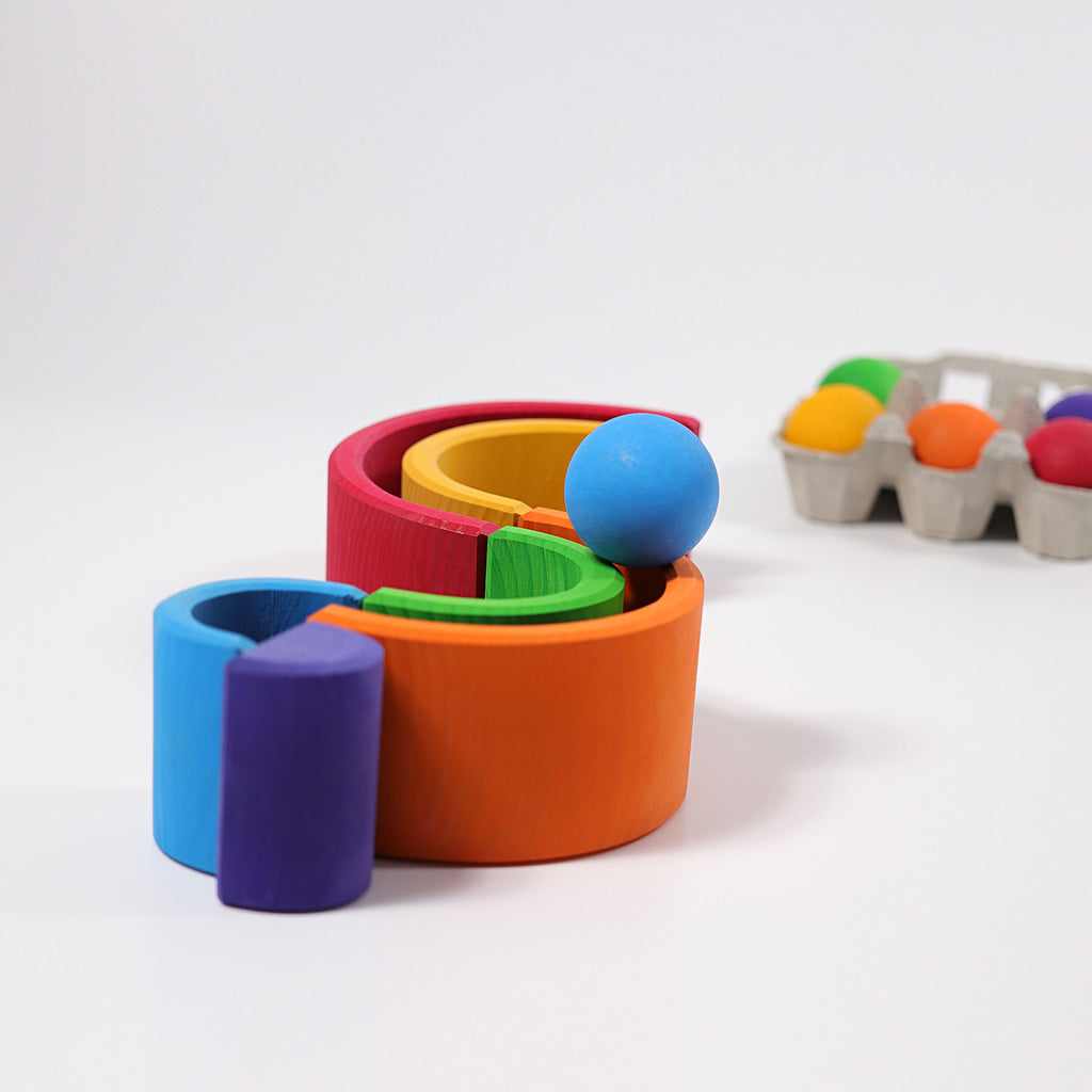 Colorful toy rings with a ball on a white background