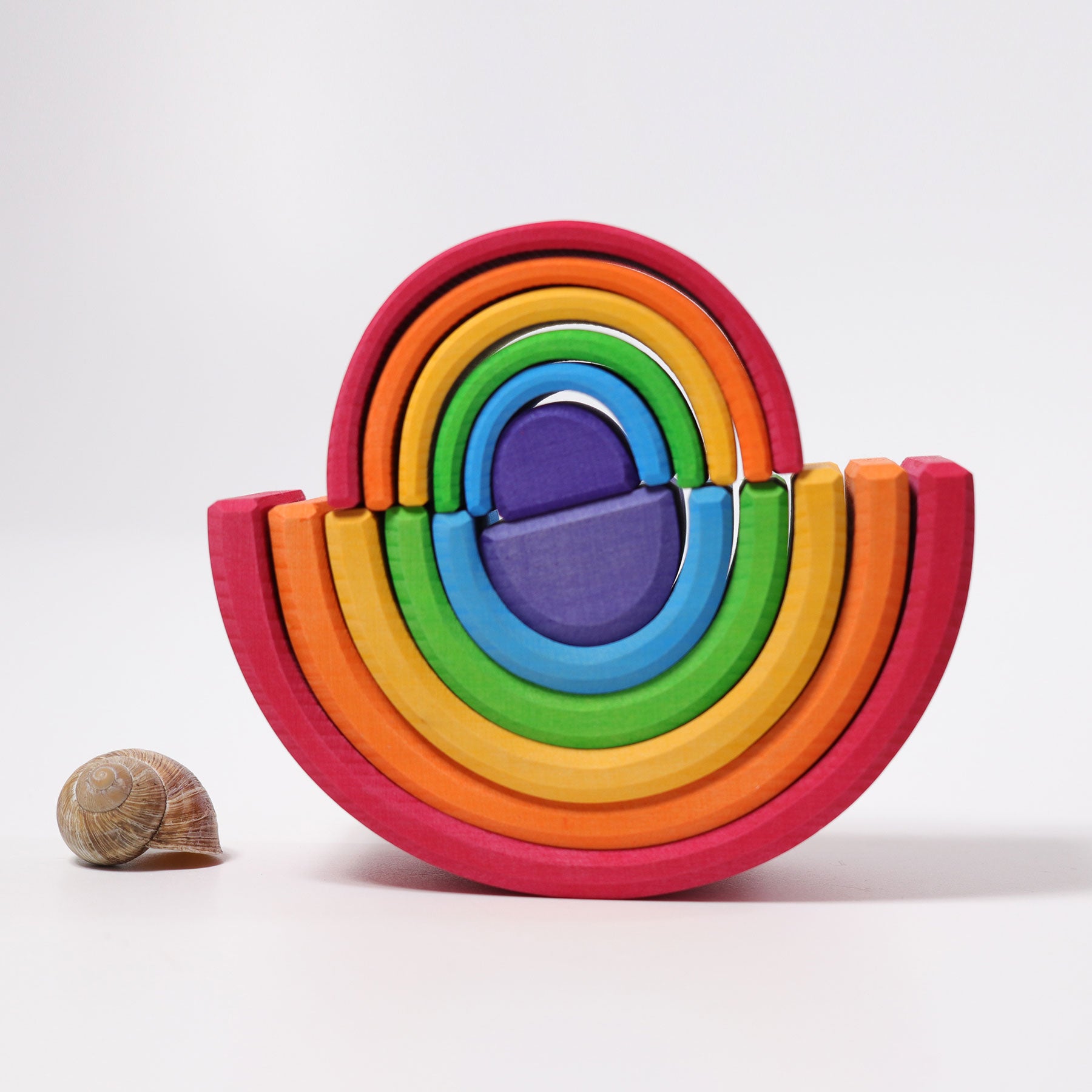 Colorful wooden ring toy with a snail on a white background