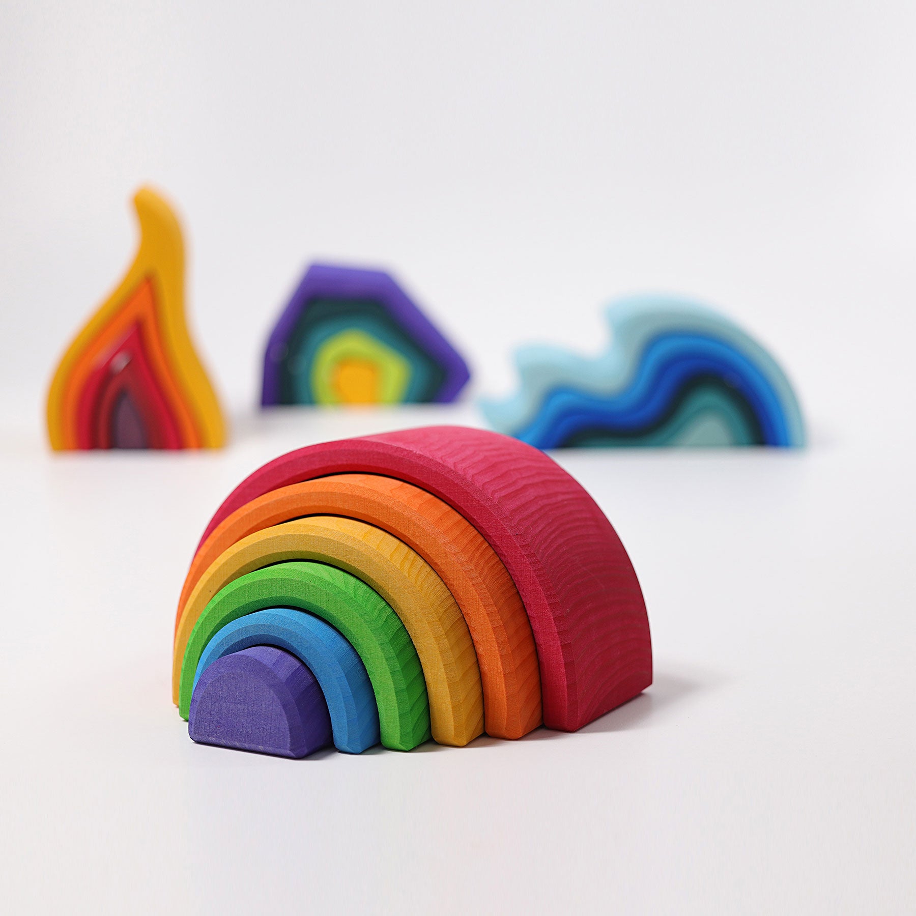 Colorful wooden rainbow toy on a white background