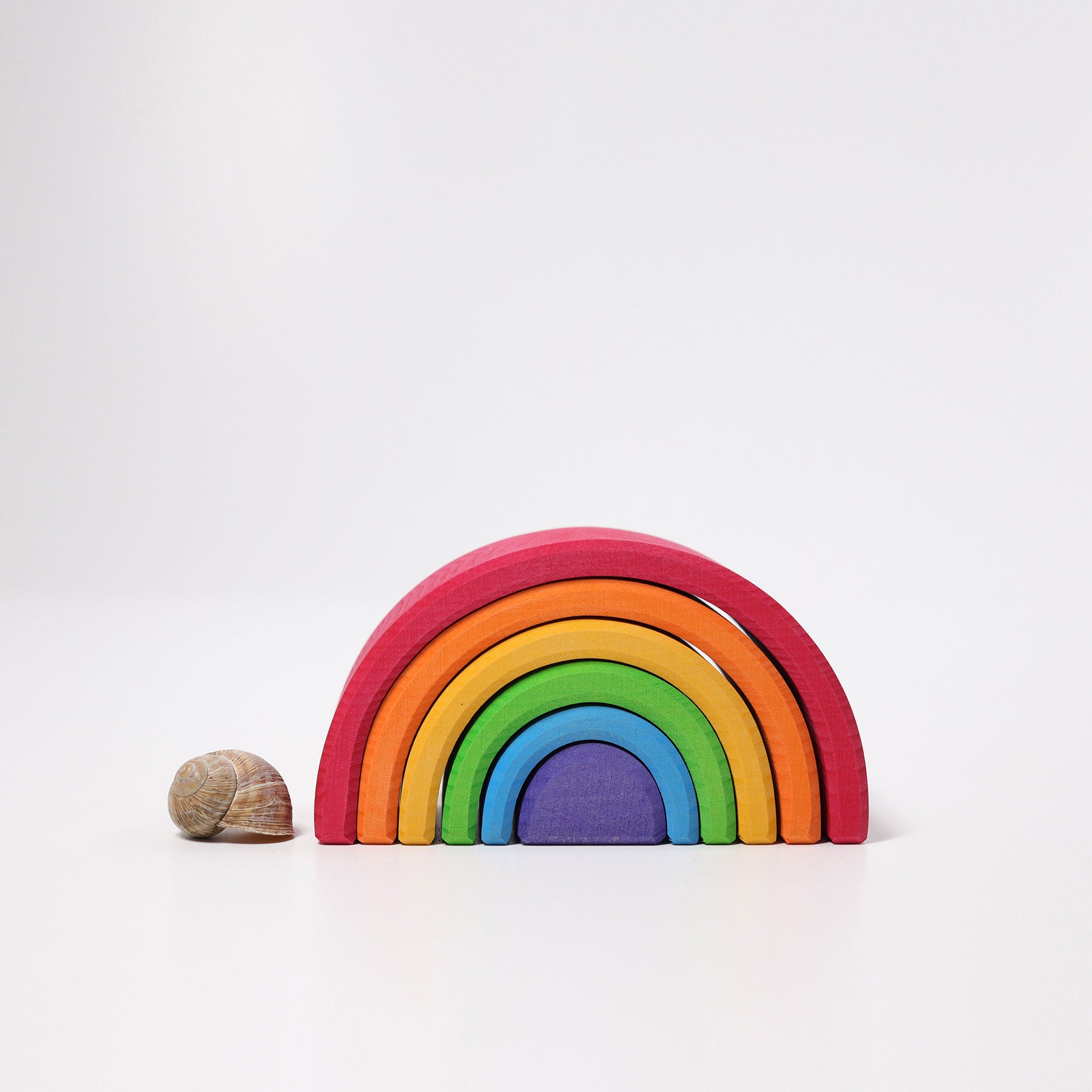 Colorful wooden rainbow toy on a white background