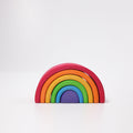 Colorful wooden rainbow toy on a white background