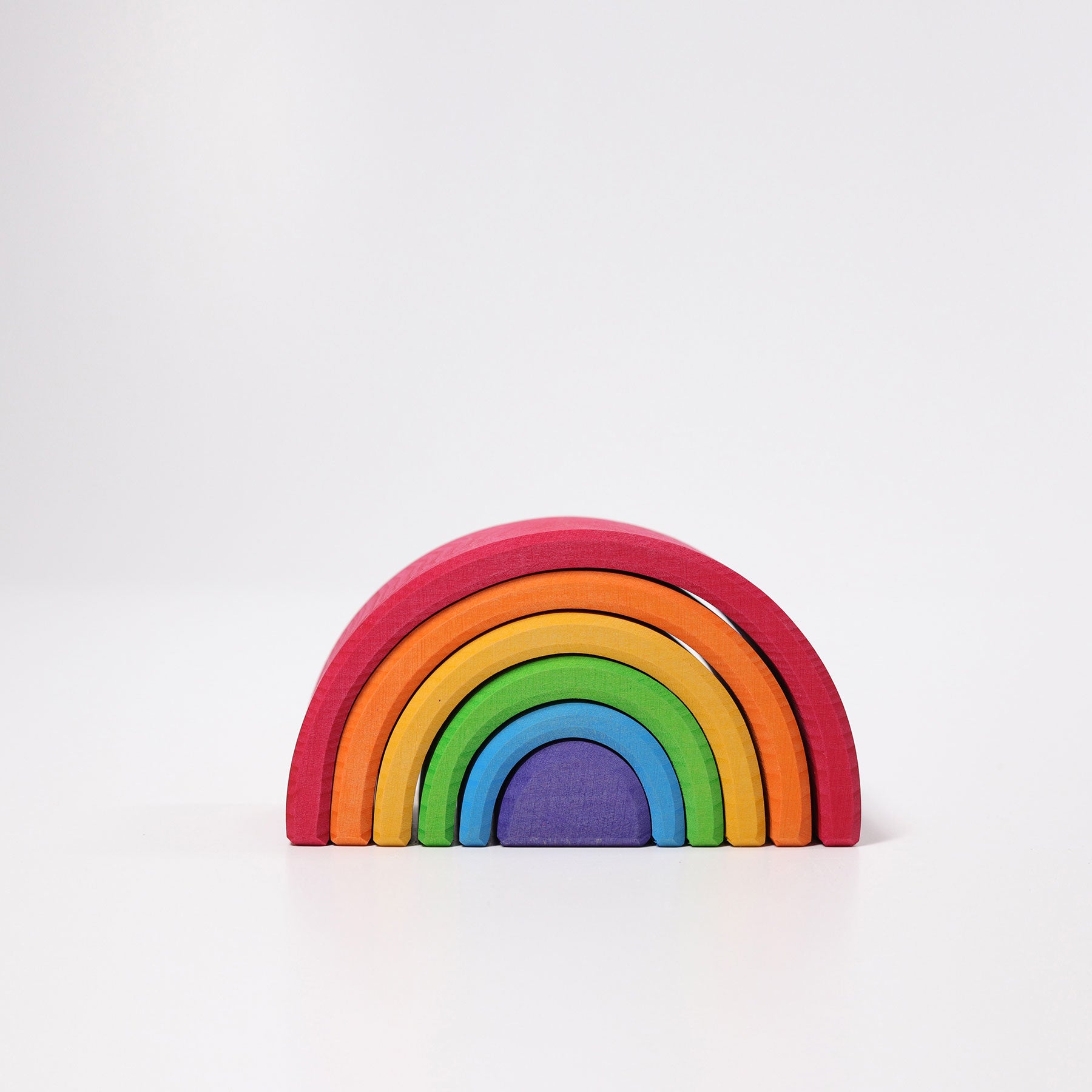 Colorful wooden rainbow toy on a white background