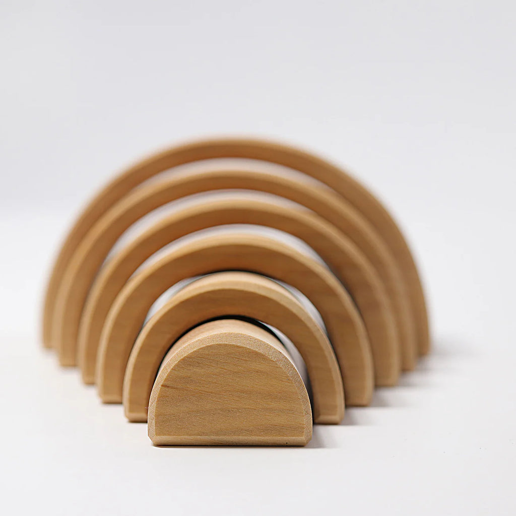 Set of wooden arch-shaped blocks on a white background
