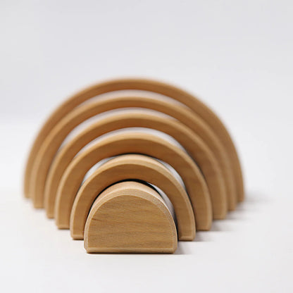 Set of wooden arch-shaped blocks on a white background