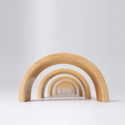 Set of wooden rainbow toys on a light gray background