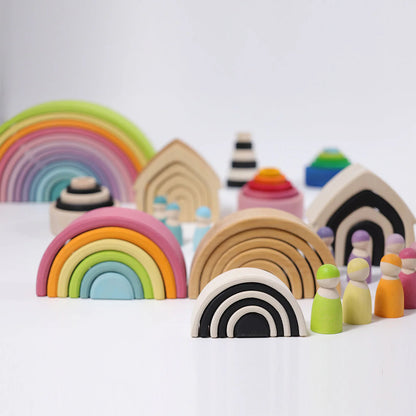 Colorful wooden toy set with rainbows and geometric shapes on a white background