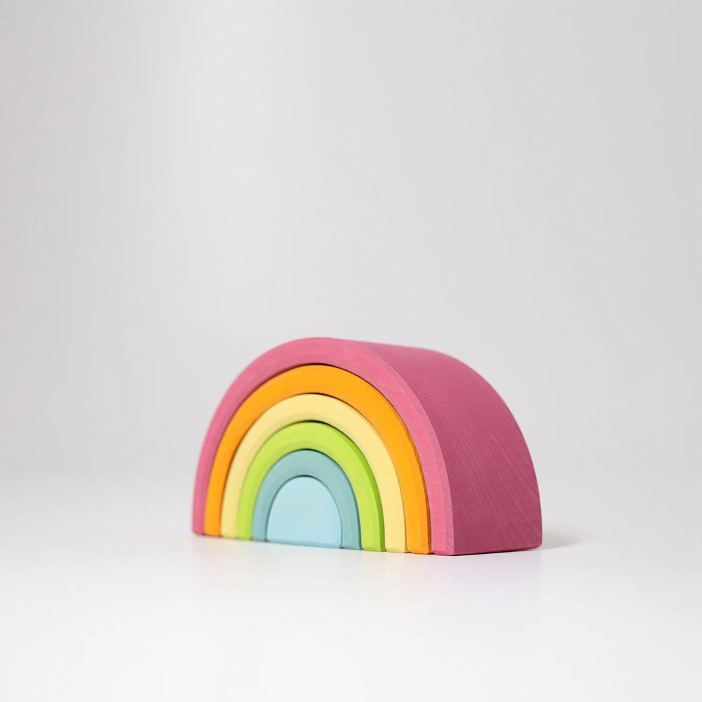 Colorful rainbow-shaped wooden block on a white background