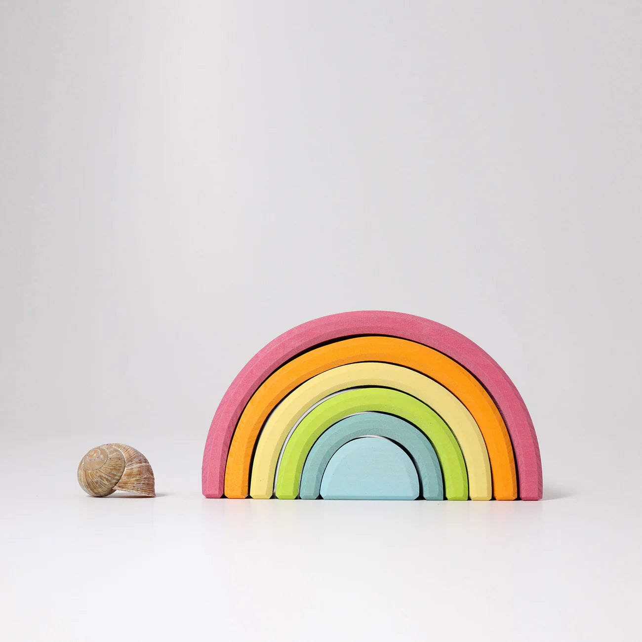 Colorful wooden rainbow toy on a white background