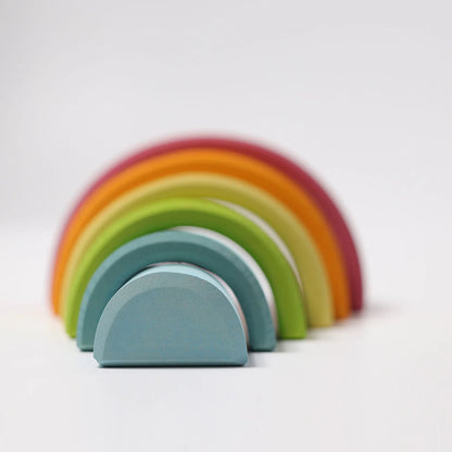 Set of colorful wooden arch-shaped toys on a light background