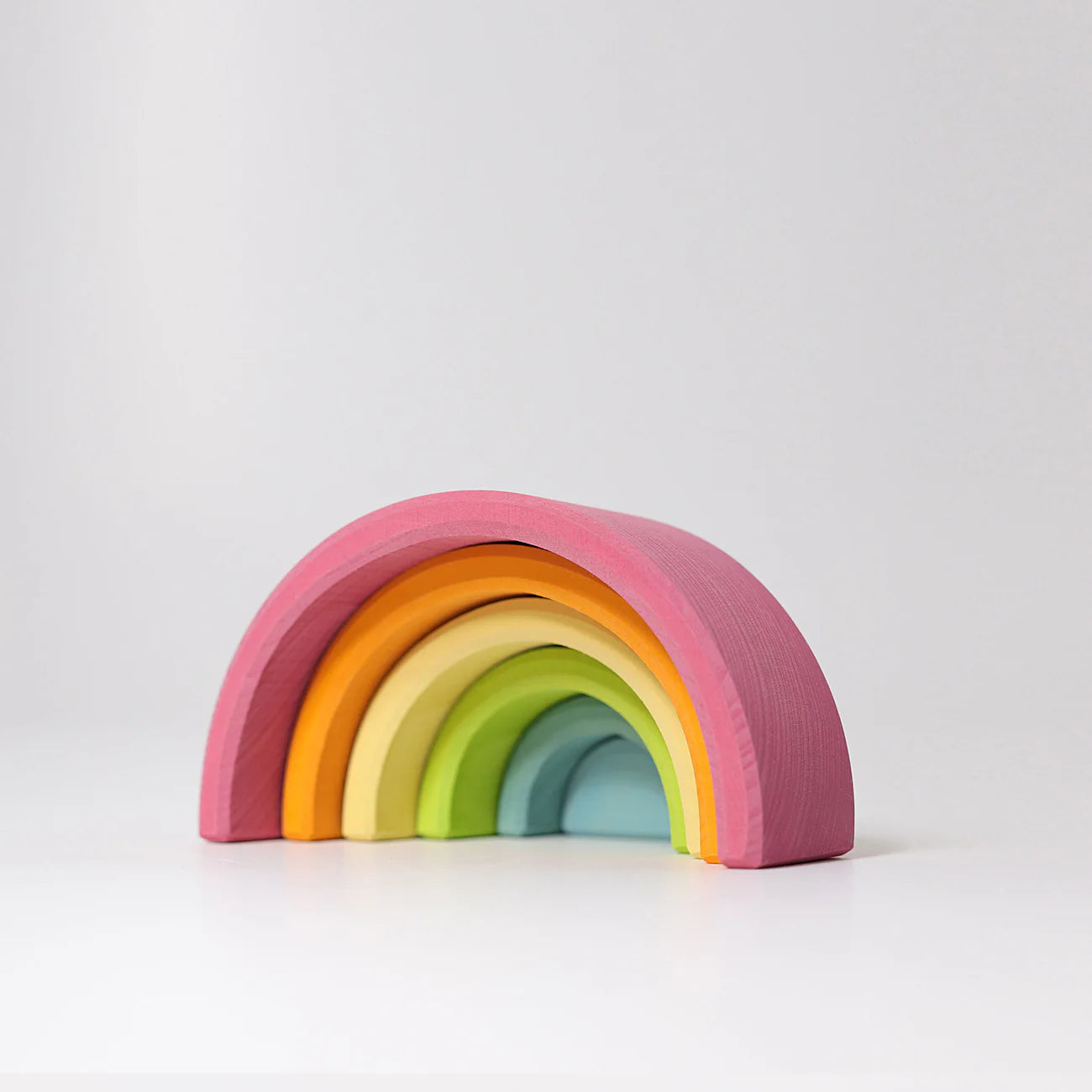 Colorful wooden rainbow toy on a white background
