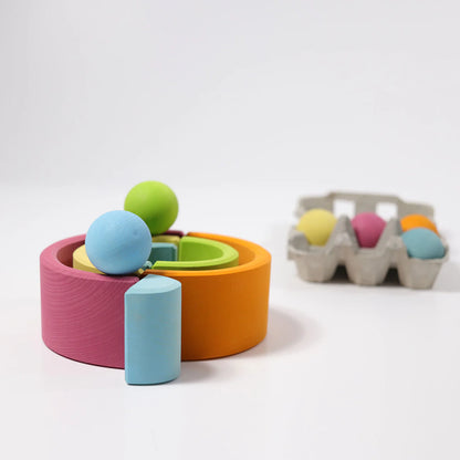 Colorful wooden toys with spheres on a white background