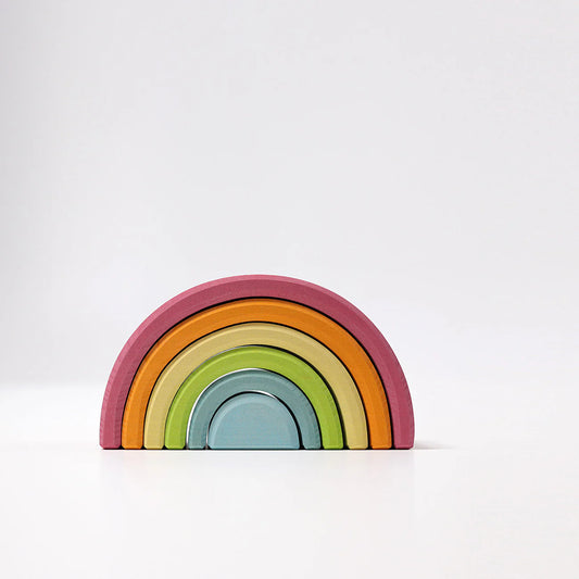 Colorful wooden rainbow toy on a white background