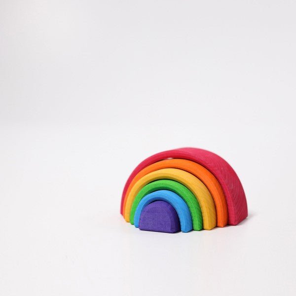 Colorful wooden rainbow toy on a white background