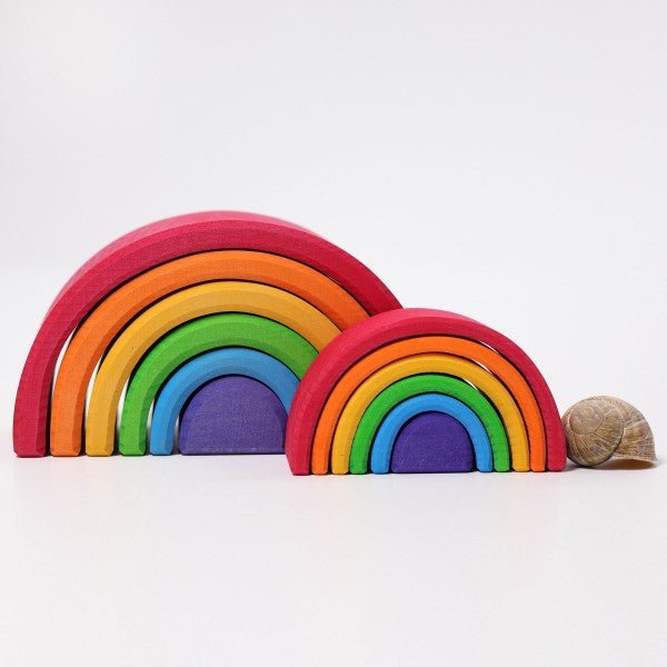 Set of colorful wooden rainbow toys on a white background