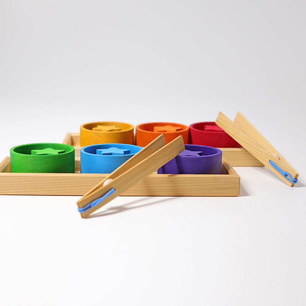Colorful wooden toys with wooden tray on a white background