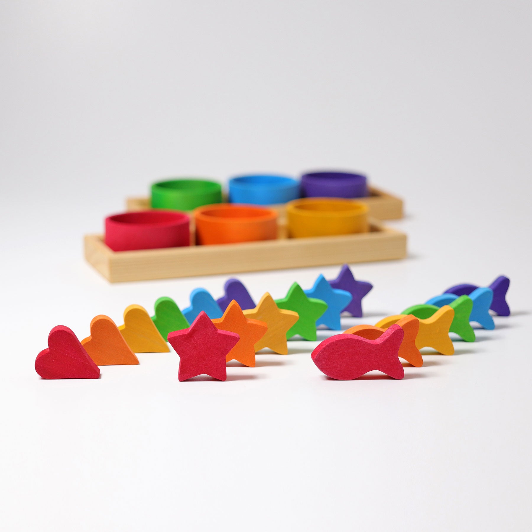 Colorful wooden shape sorting toy with various shapes on a white background