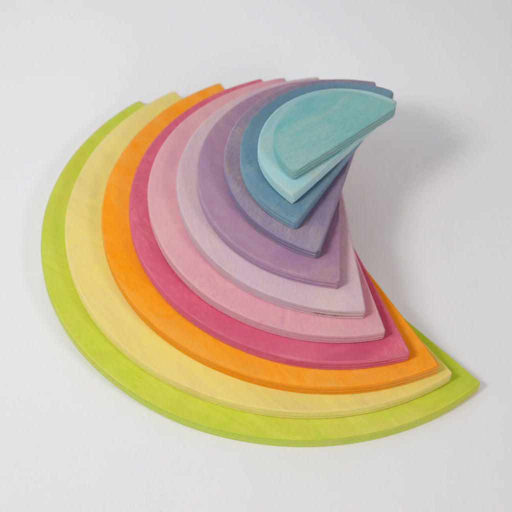 Set of colorful wooden shapes arranged in a semi-circle on a white background