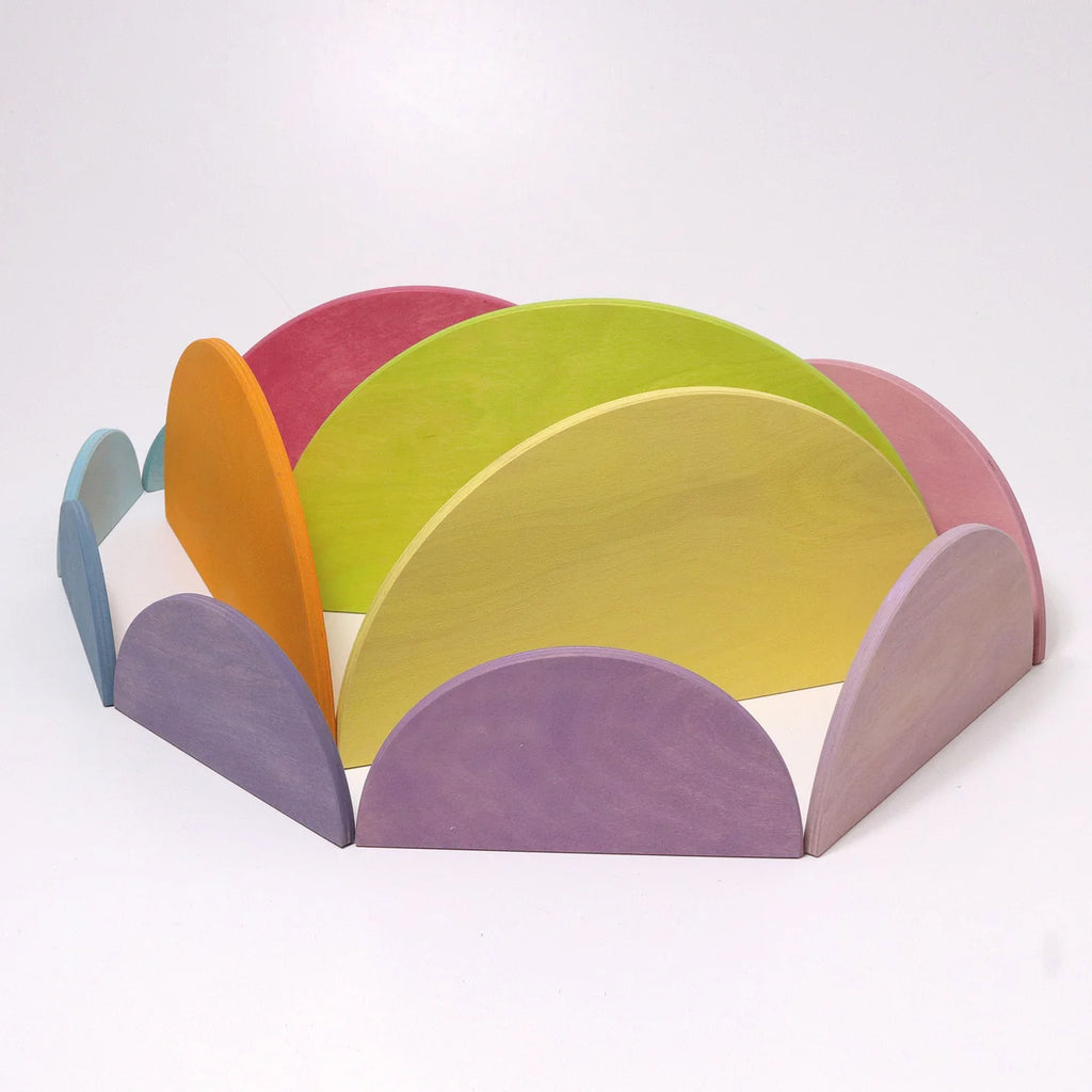 Colorful semi-circular wooden toys on a white background