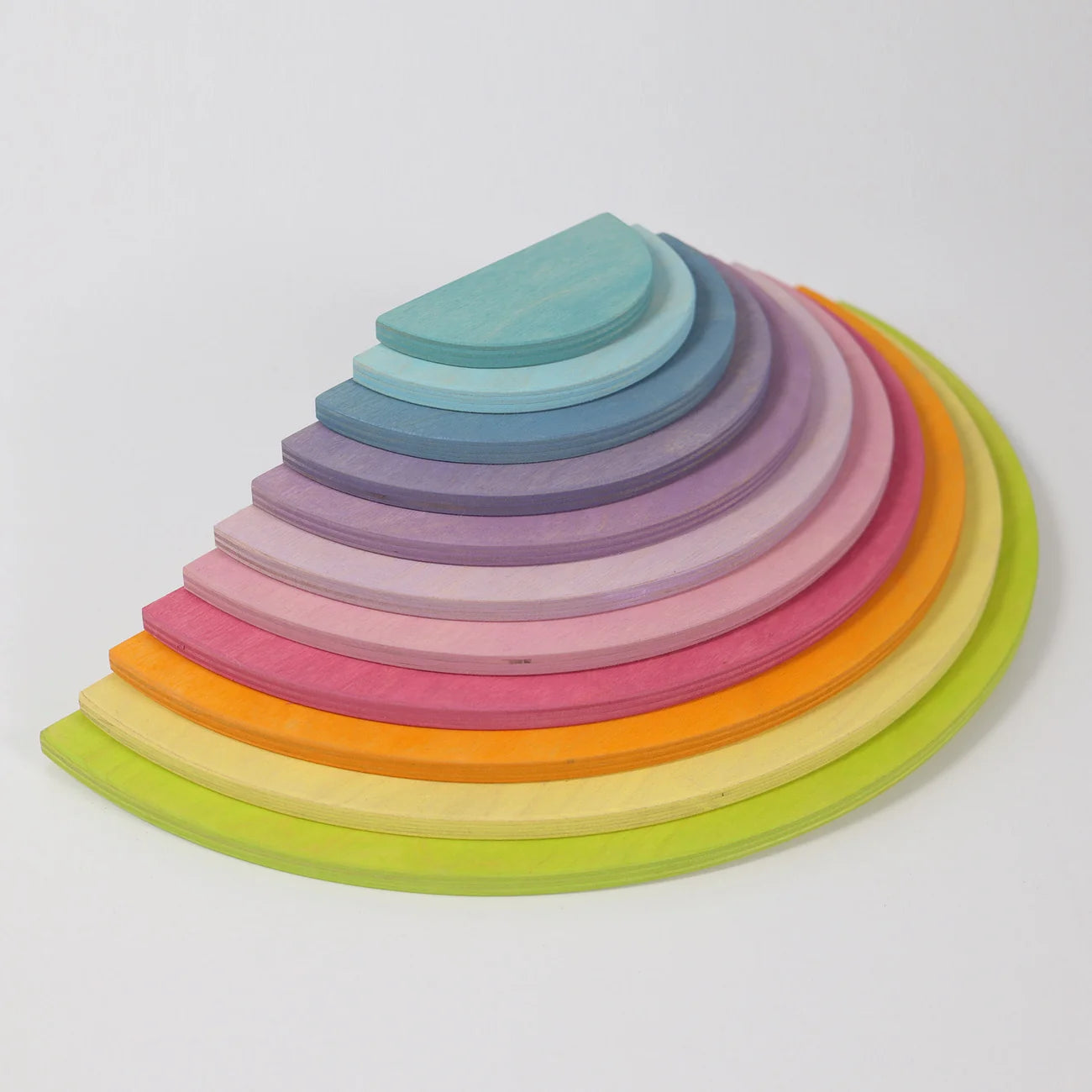 Set of colorful wooden rings stacked in a pyramid shape on a white background