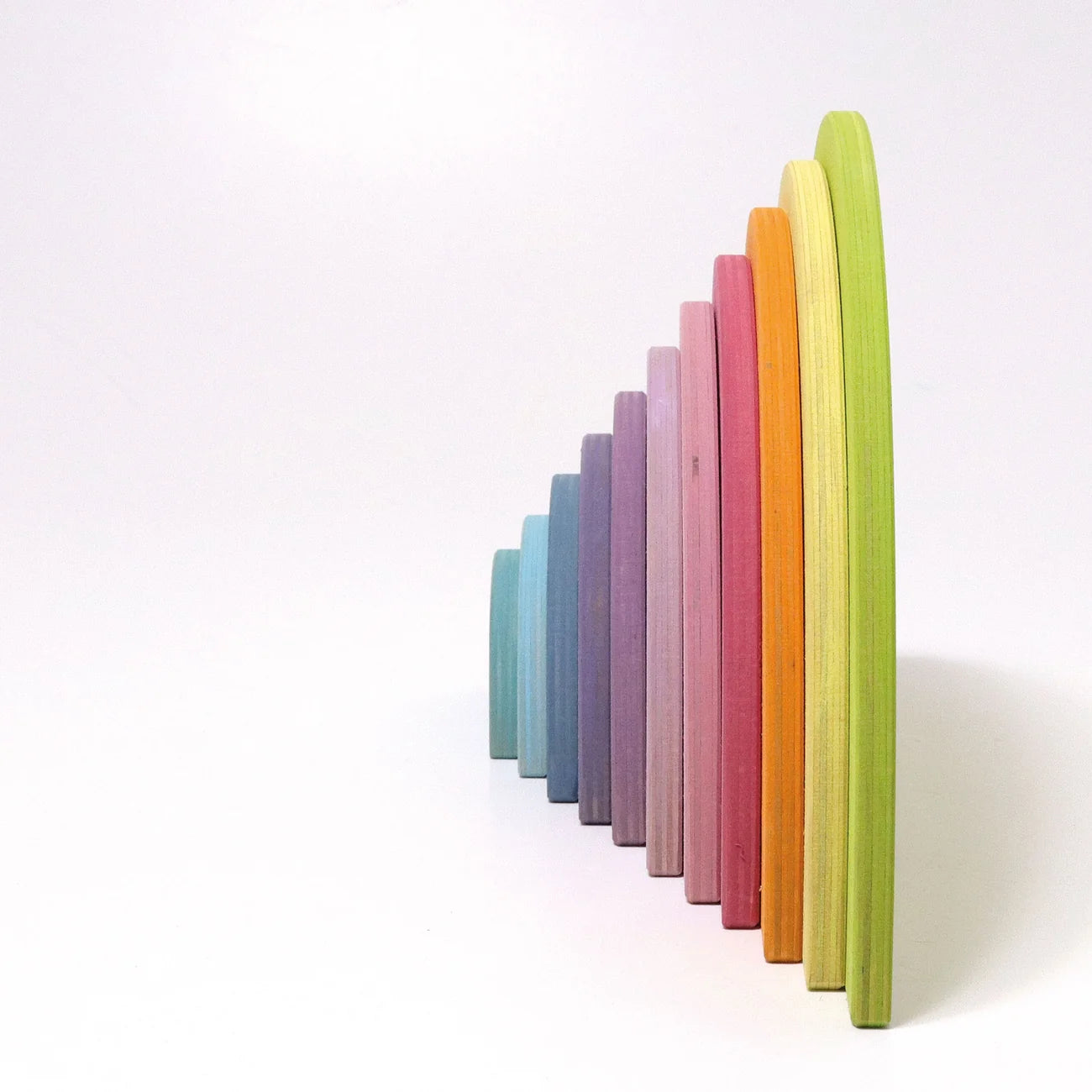 Set of colorful wooden toys stacked on a white background