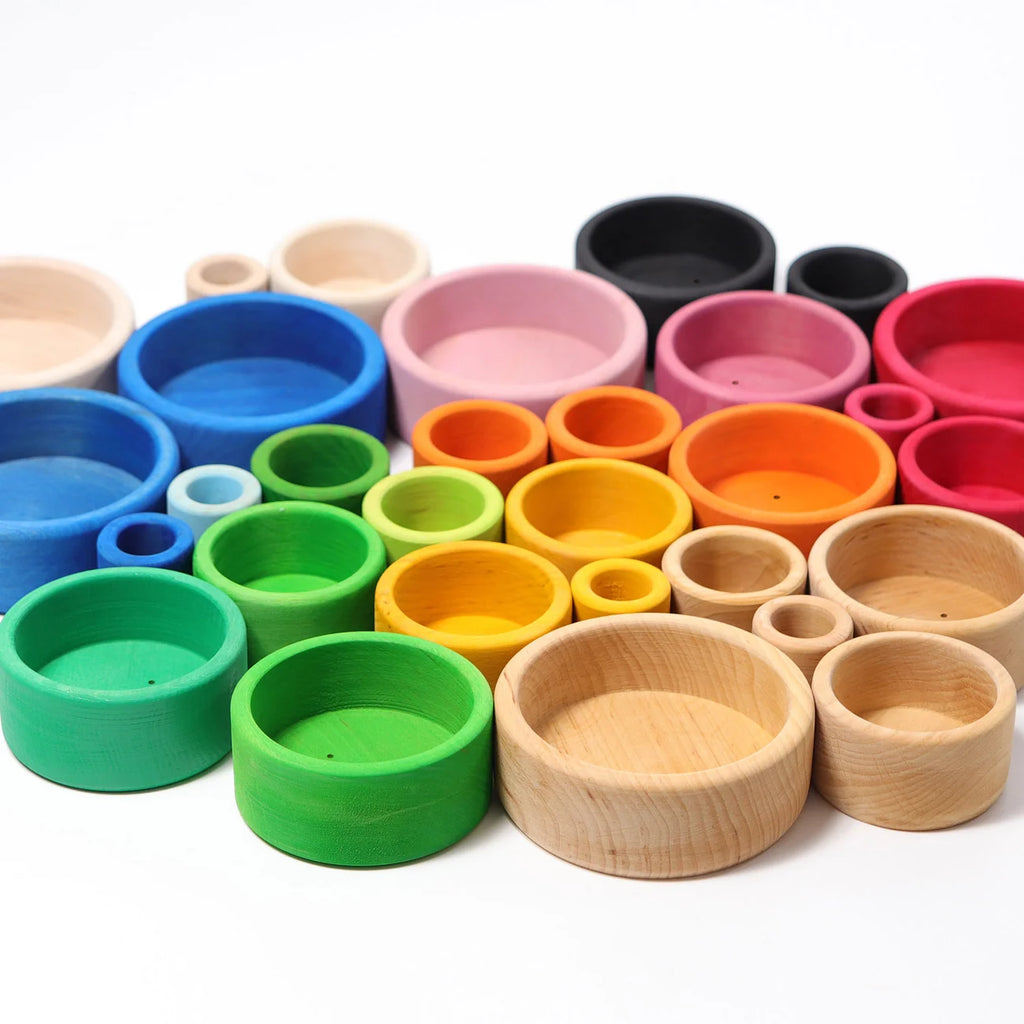 Assorted colorful wooden bowls on a white background