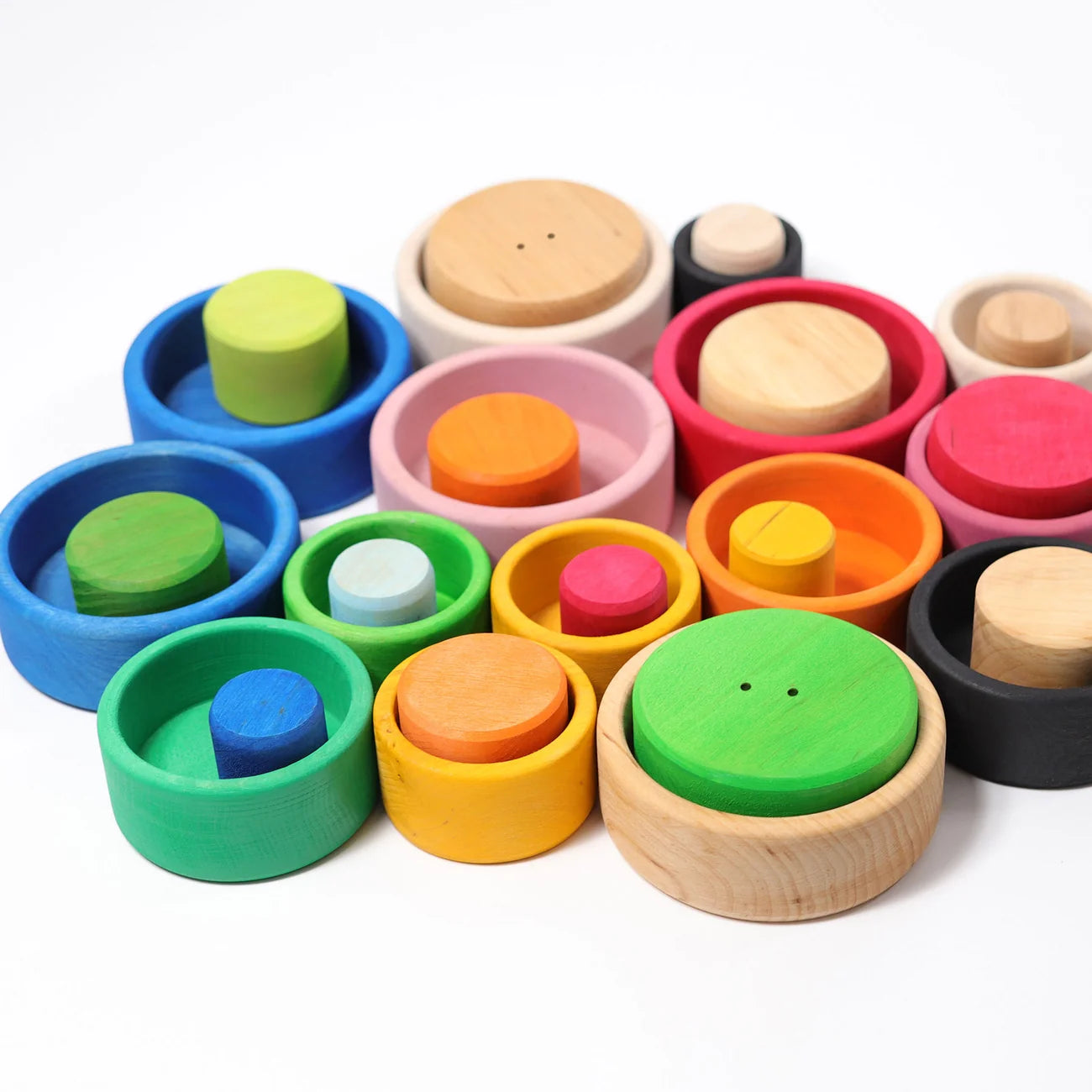 Colorful wooden toys with circular shapes on a white background