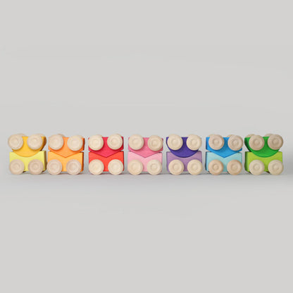 Colorful building blocks arranged in a row on a light gray background
