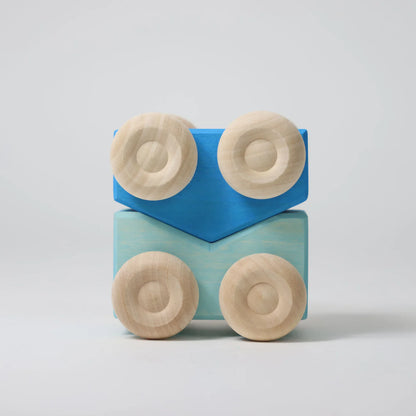 Two wooden blocks with circular ends stacked on a light gray background