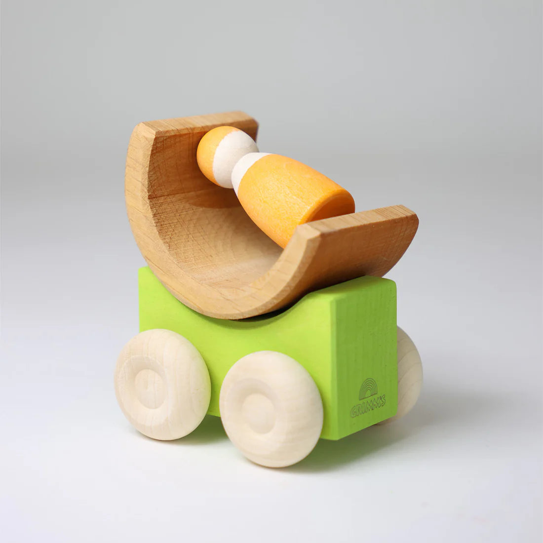 Wooden toy with a green base and brown top on a light gray background