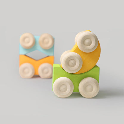 Colorful wooden toy blocks with wheels on a gray background